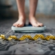 A woman's feet standing on a bathroom scale with a tape measure on the floor